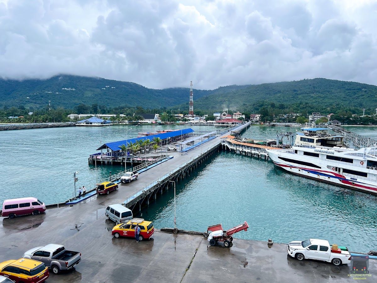 Nathon Pier on Koh Samui's west coast, with a large white ferry docked alongside the pier and vehicles on the approach road