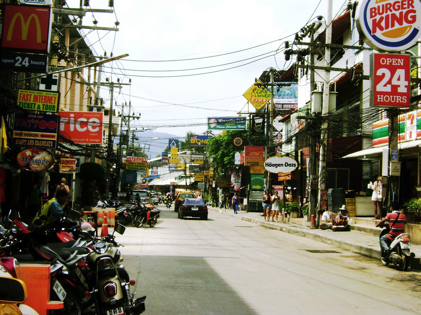 Chaweng Beach Road, Koh Samui, a busy strip of shops and signs