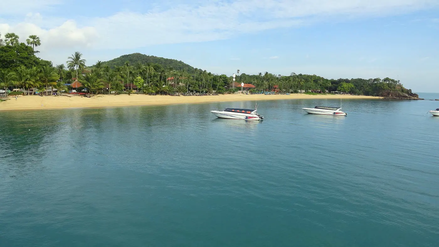 Maenam Beach, a long quiet stretch of sand with long-tail boats offshore