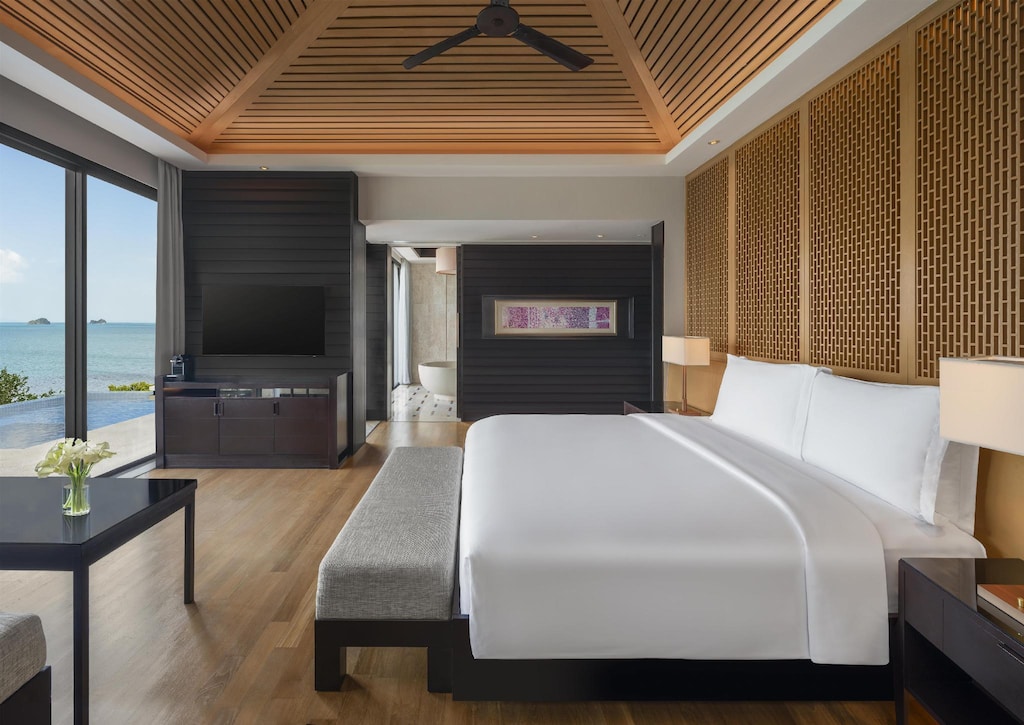 Conrad Koh Samui villa bedroom opening onto a balcony and private pool