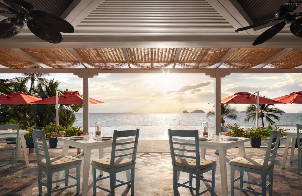 Jahn by Zest restaurant at Conrad Koh Samui, set tables and a long view to the water