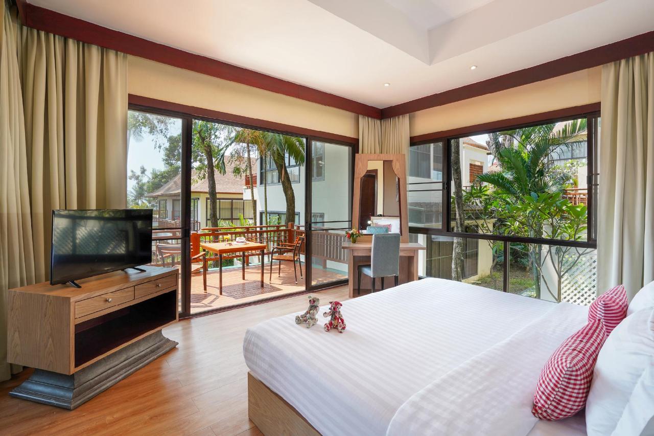 Bedroom at The Briza Beach Resort looking through glass doors at a small rectangular plunge pool