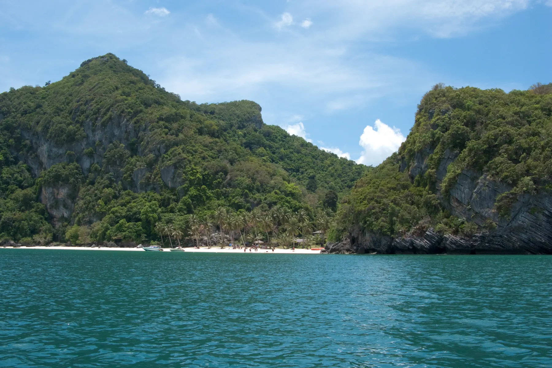A limestone island in Mu Ko Ang Thong marine park, with steep cliffs rising from deep blue water