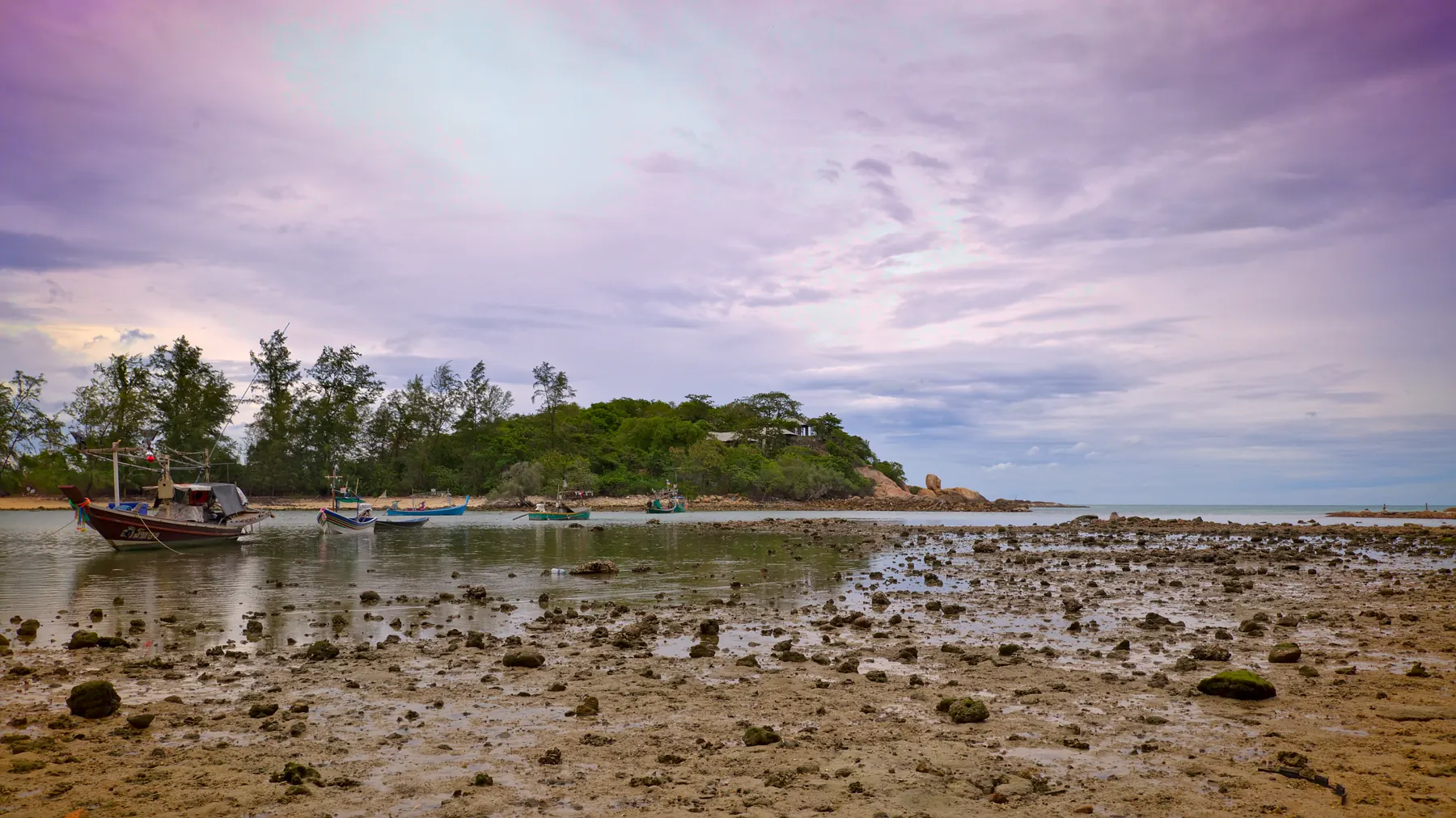 Choeng Mon Beach, Koh Samui, a sheltered bay of turquoise water between a green headland and limestone rocks