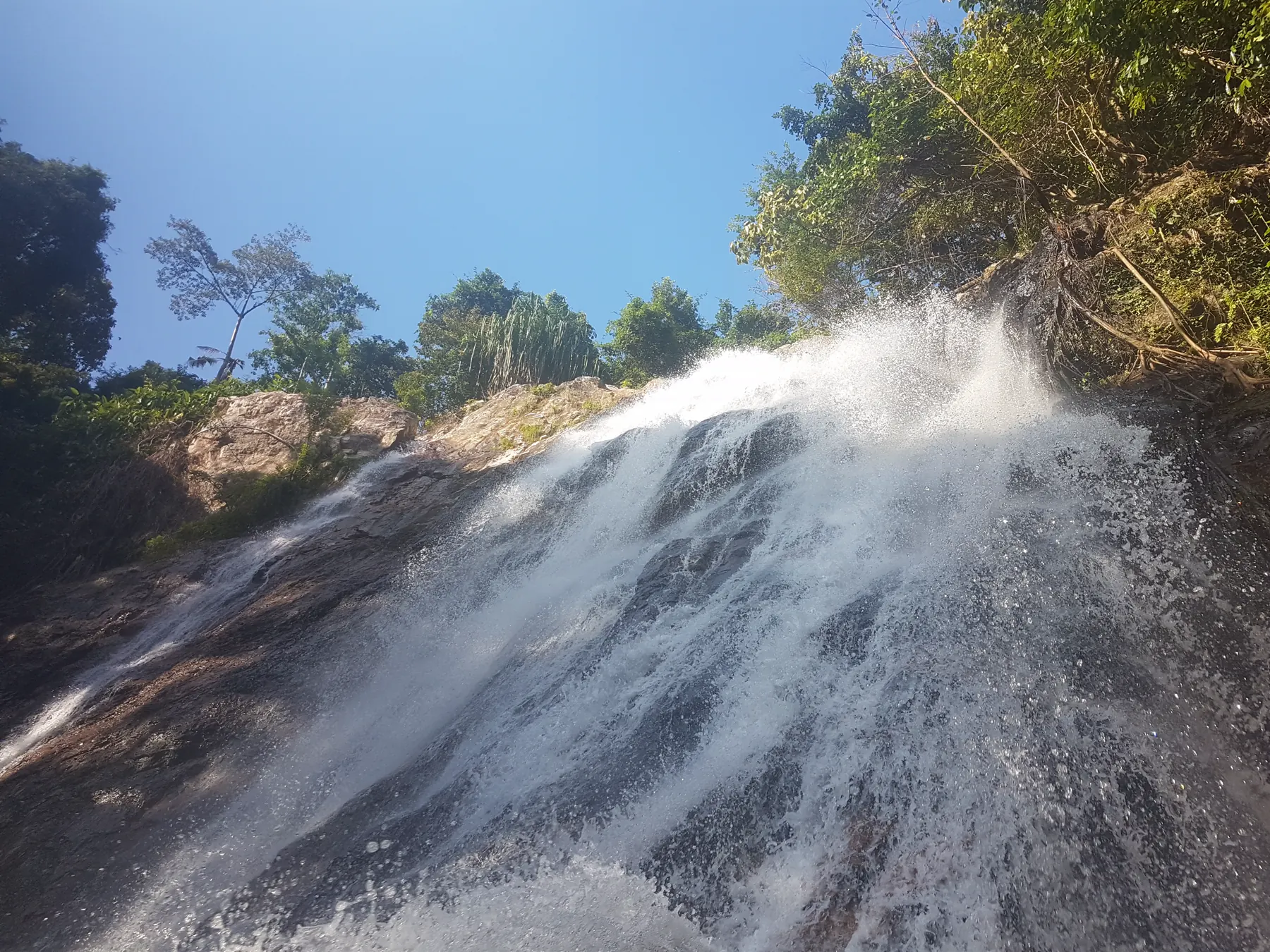 Na Muang 2 waterfall on Koh Samui, a wide cascade into a green pool in the forest